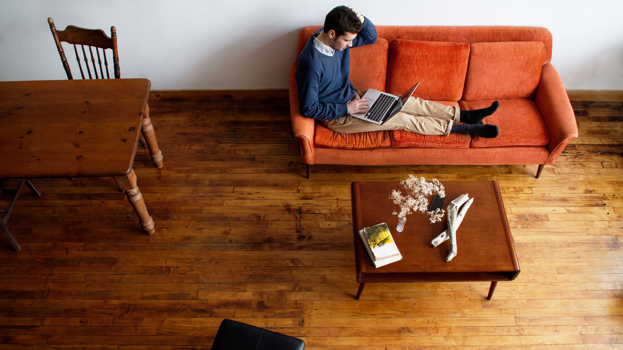 man sitting on couch with laptop