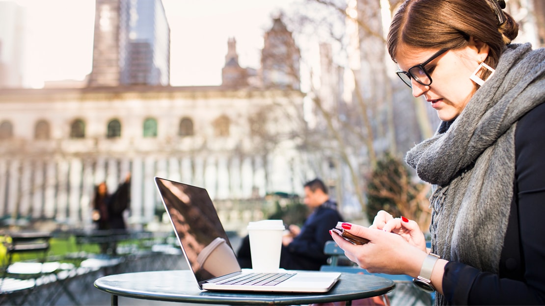woman on phone and laptop